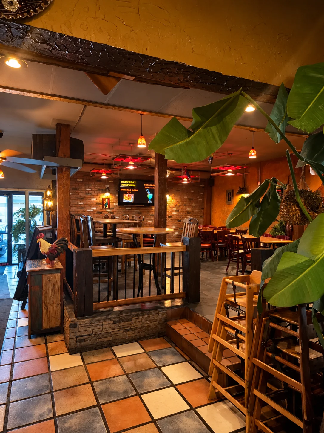 Family seating area with high chairs and warm pendant lighting at Habaneros Mexican Grill, a family-run Mexican restaurant in Leduc